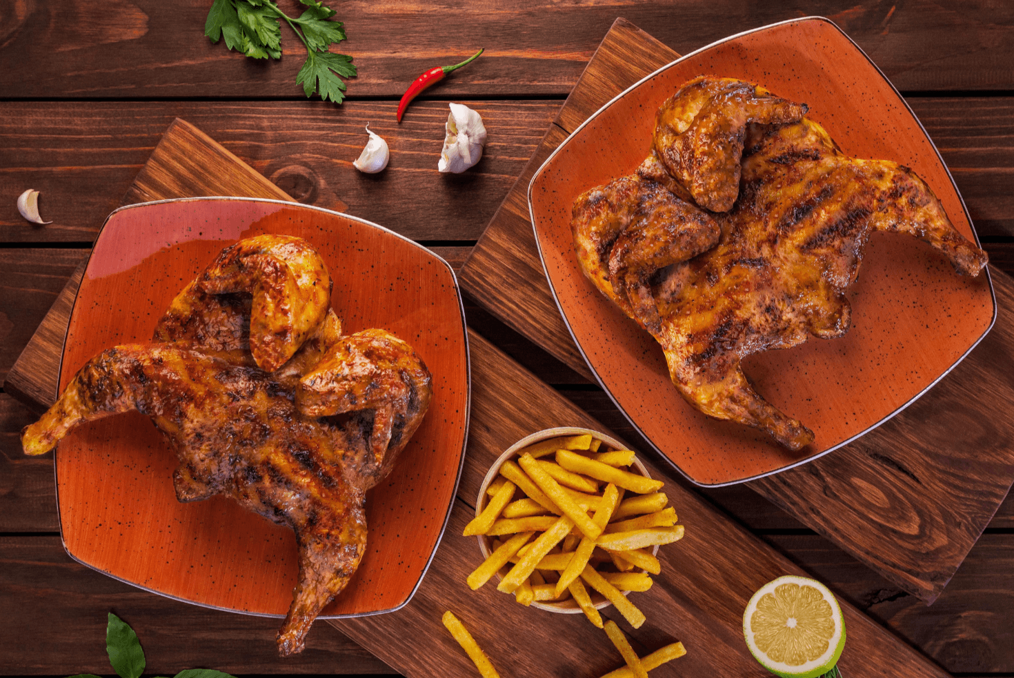 Two Barcelos flame-grilled chickens with chips